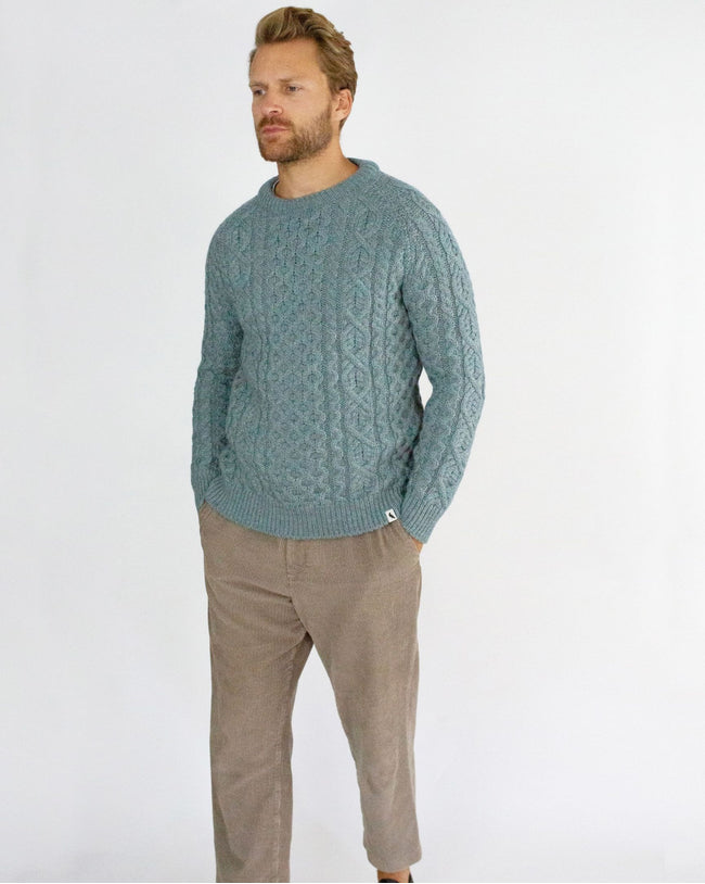 Image of model wearing Hudson Aran Jumper. Model is 6ft1in, chest size 40in and wearing size Large