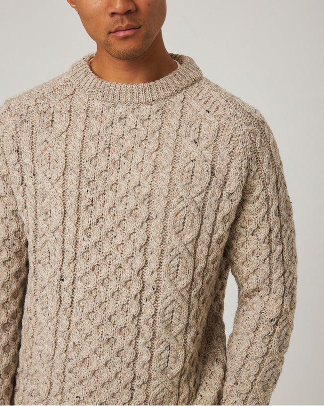 Image of model wearing Hudson Aran Jumper. Model is 6ft, chest size 36in and wearing size Large