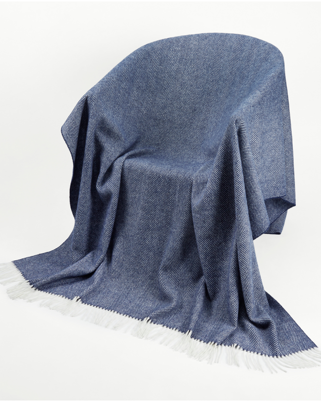 Image of model wearing Wool Blanket. SIZE: 185CM X 140CM (INCLUDES FRINGE)