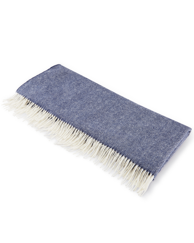Image of model wearing Wool Blanket. SIZE: 185CM X 140CM (INCLUDES FRINGE)
