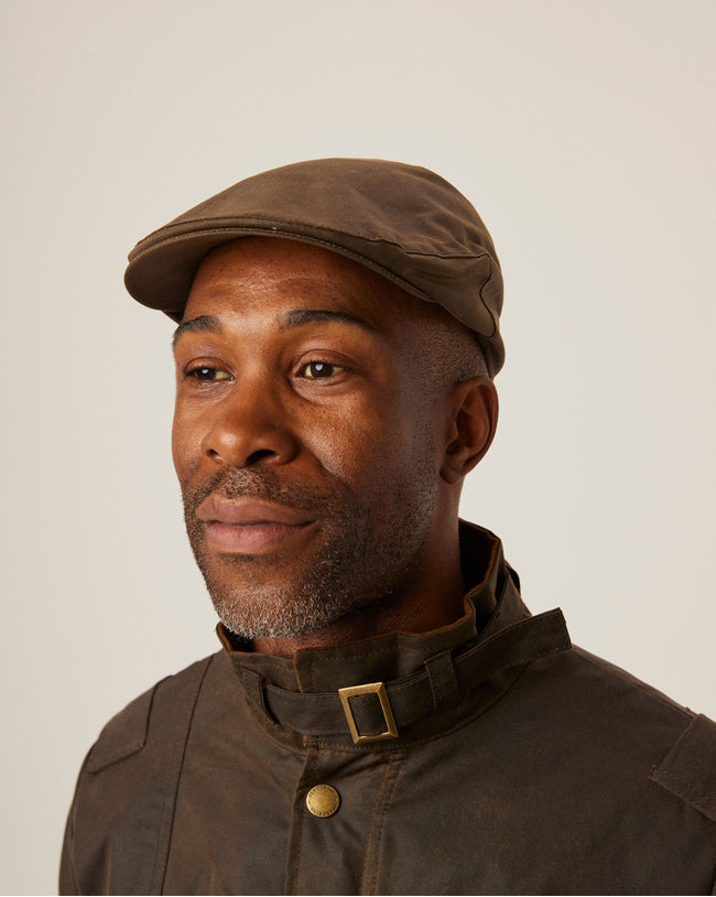 Image of model wearing Wax Flat Cap.