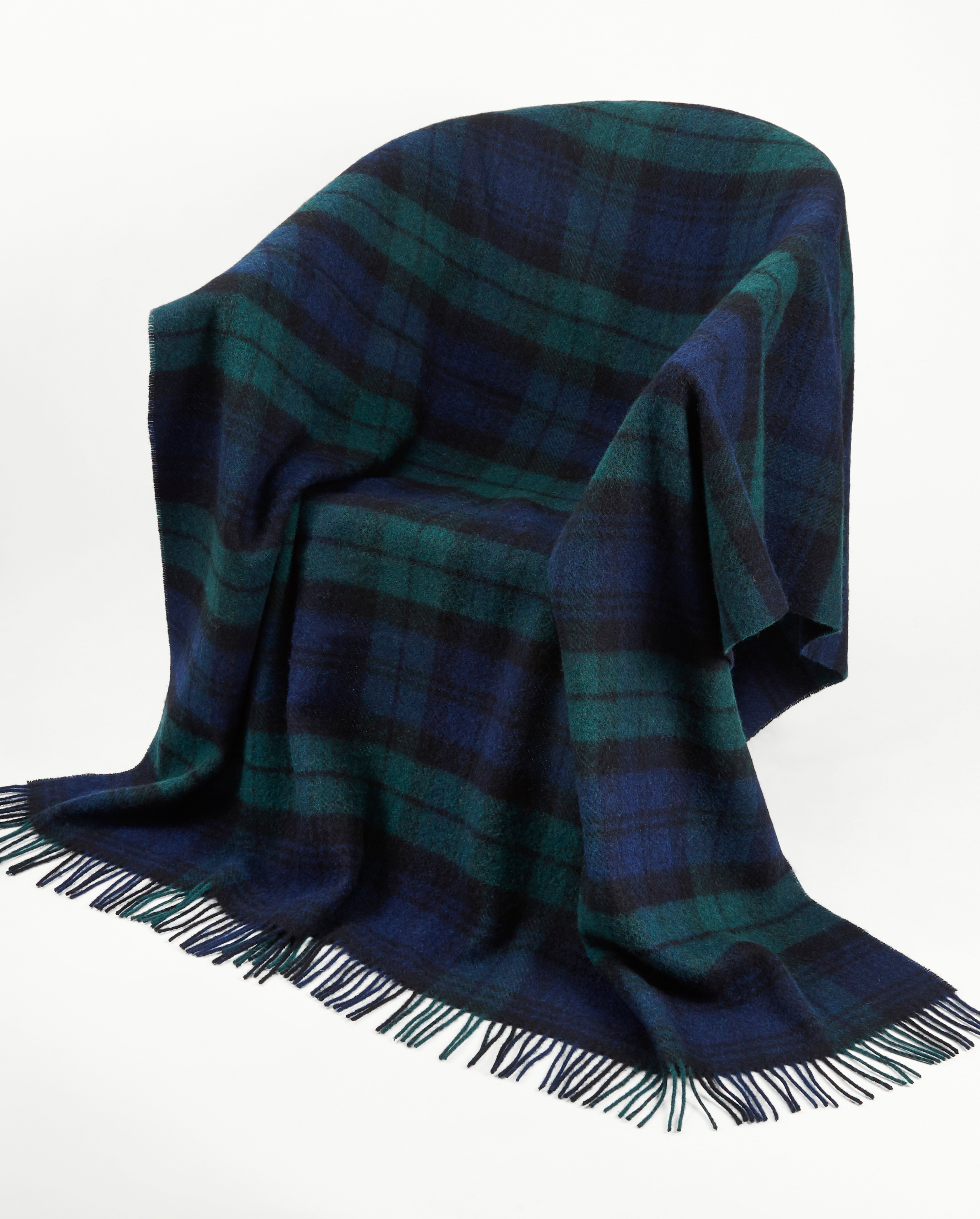 Image of model wearing Wool Blanket. SIZE: 185CM X 140CM (INCLUDES FRINGE)