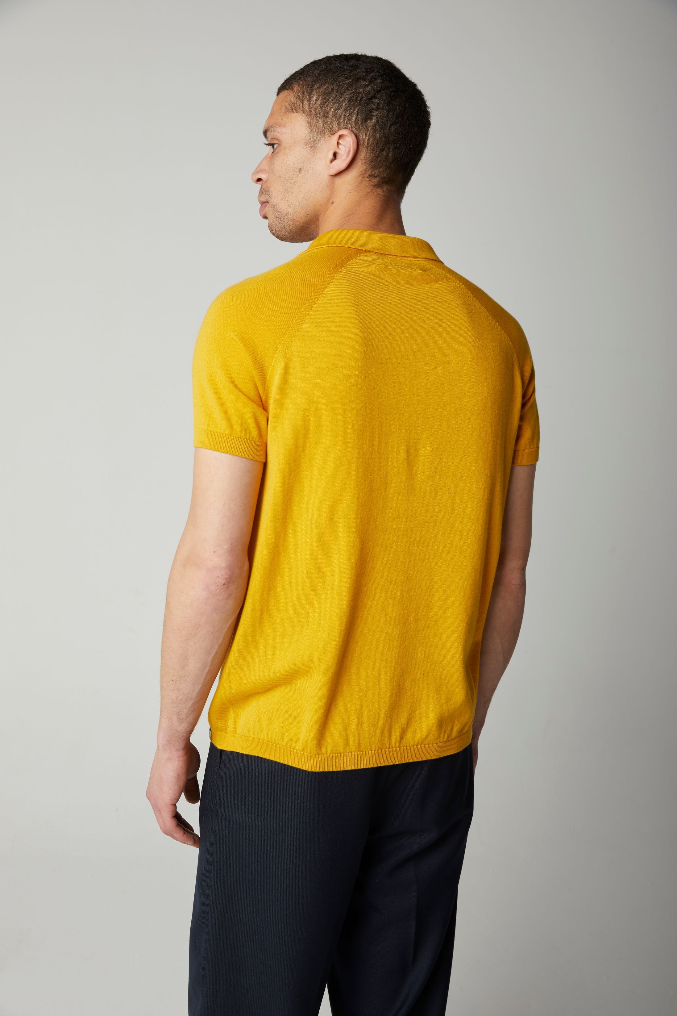 Image of model wearing Knitted Emery Polo Shirt. Model is 6ft, chest size 36in and wearing size Medium