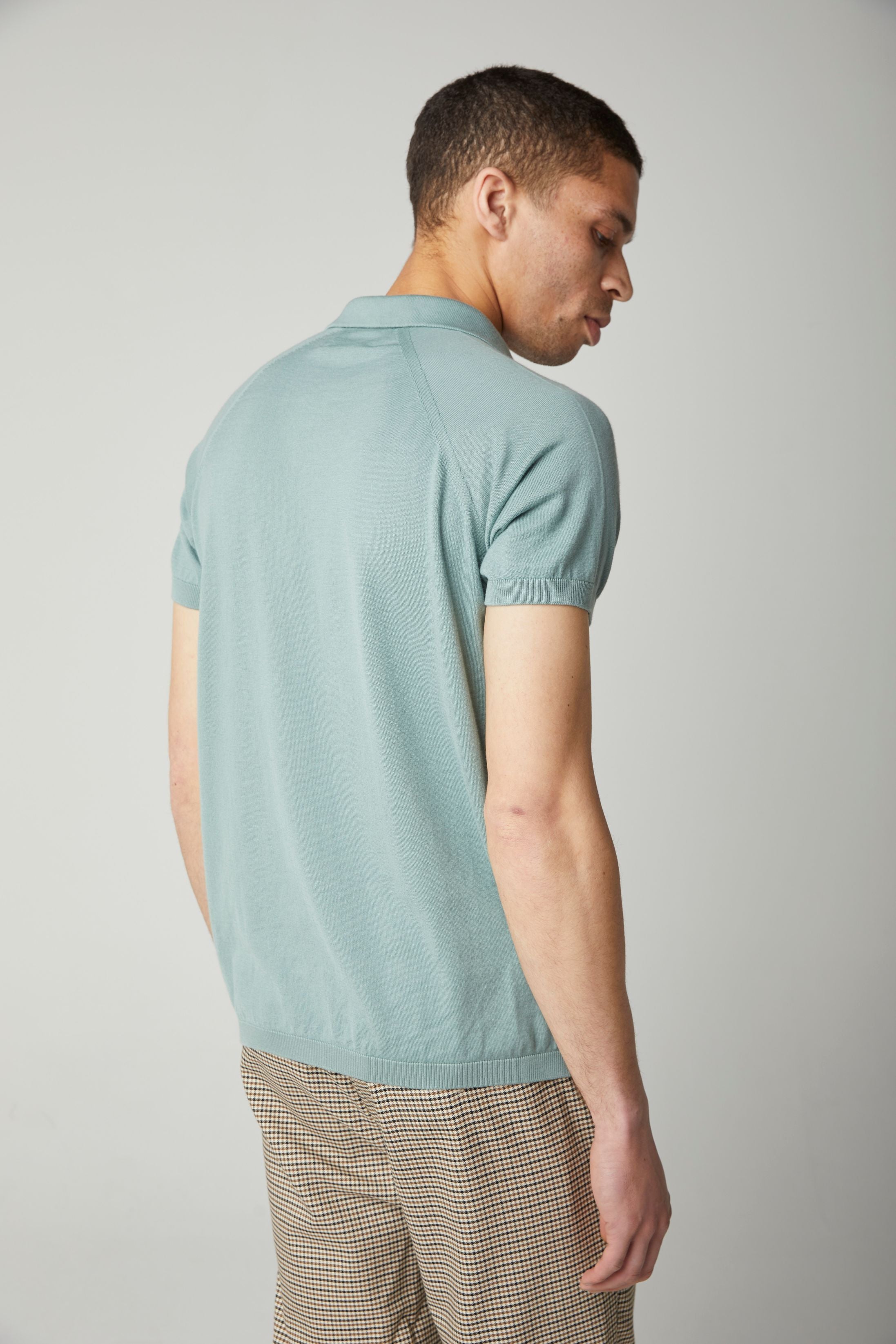 Image of model wearing Knitted Emery Polo Shirt. Model is 6ft, chest size 36in and wearing size Medium