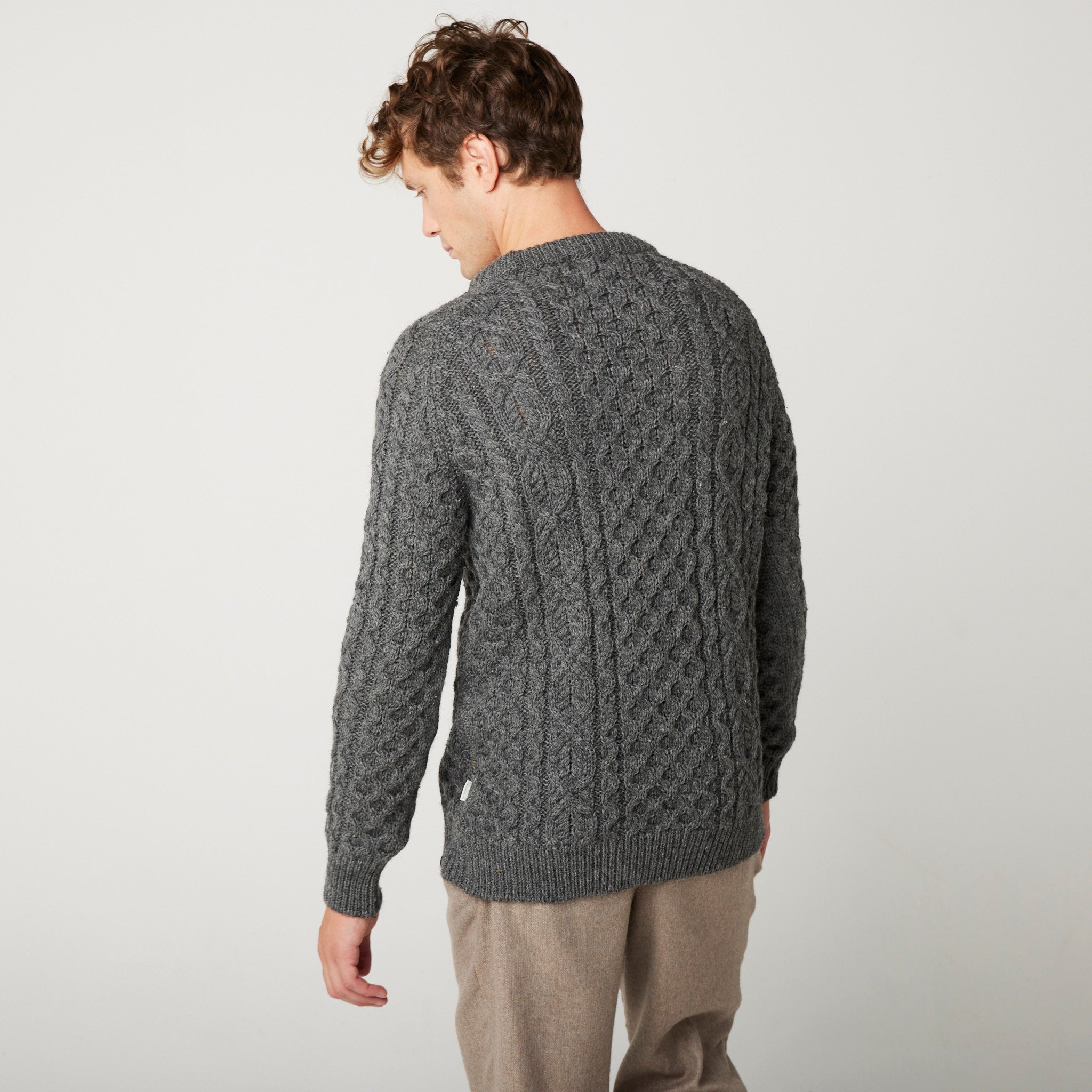 Image of model wearing Hudson Aran Jumper. Model is 6ft1in, chest size 38in and wearing size Medium