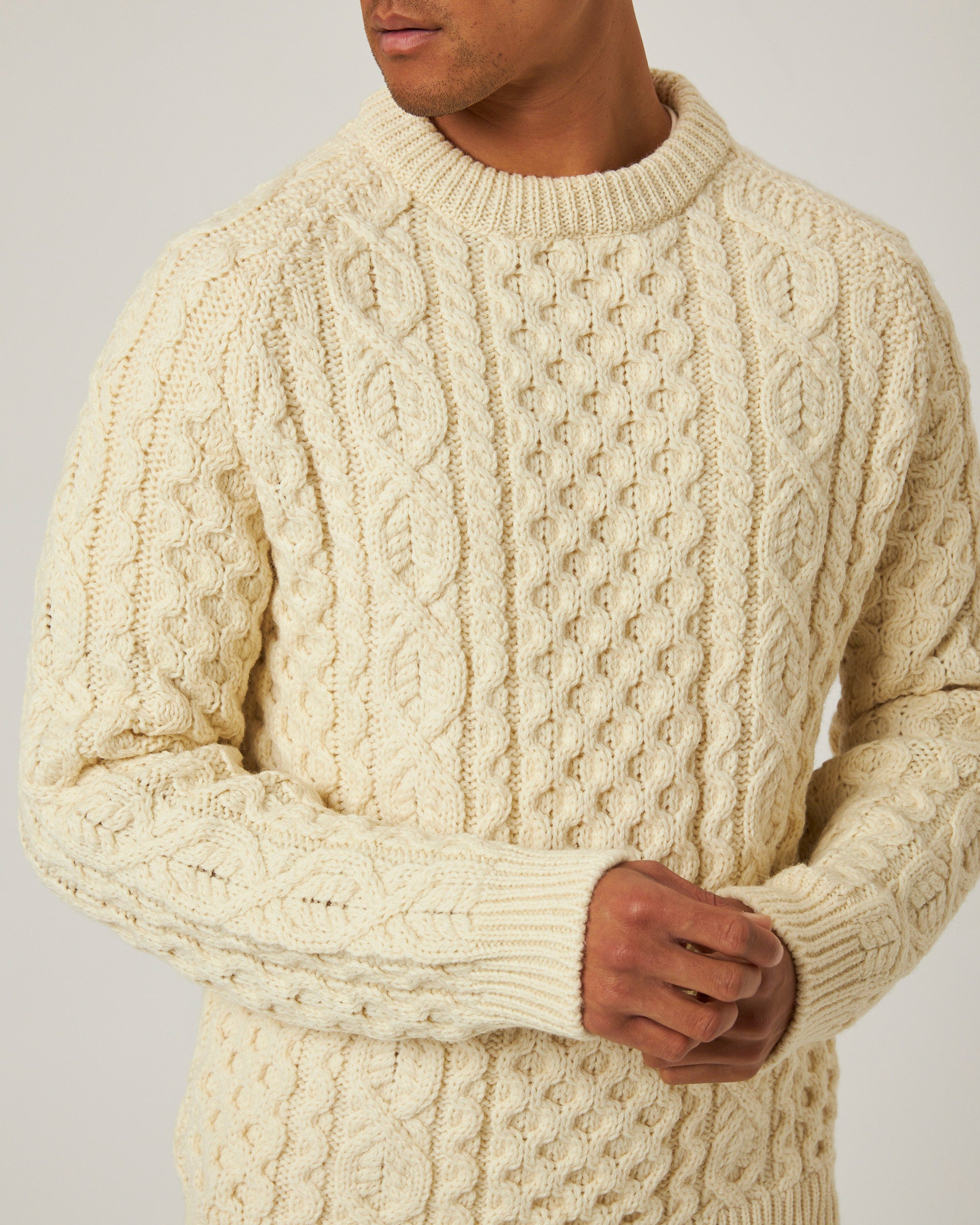Image of model wearing Hudson Aran Jumper. Model is 6ft1in, chest size 38in and wearing size Large