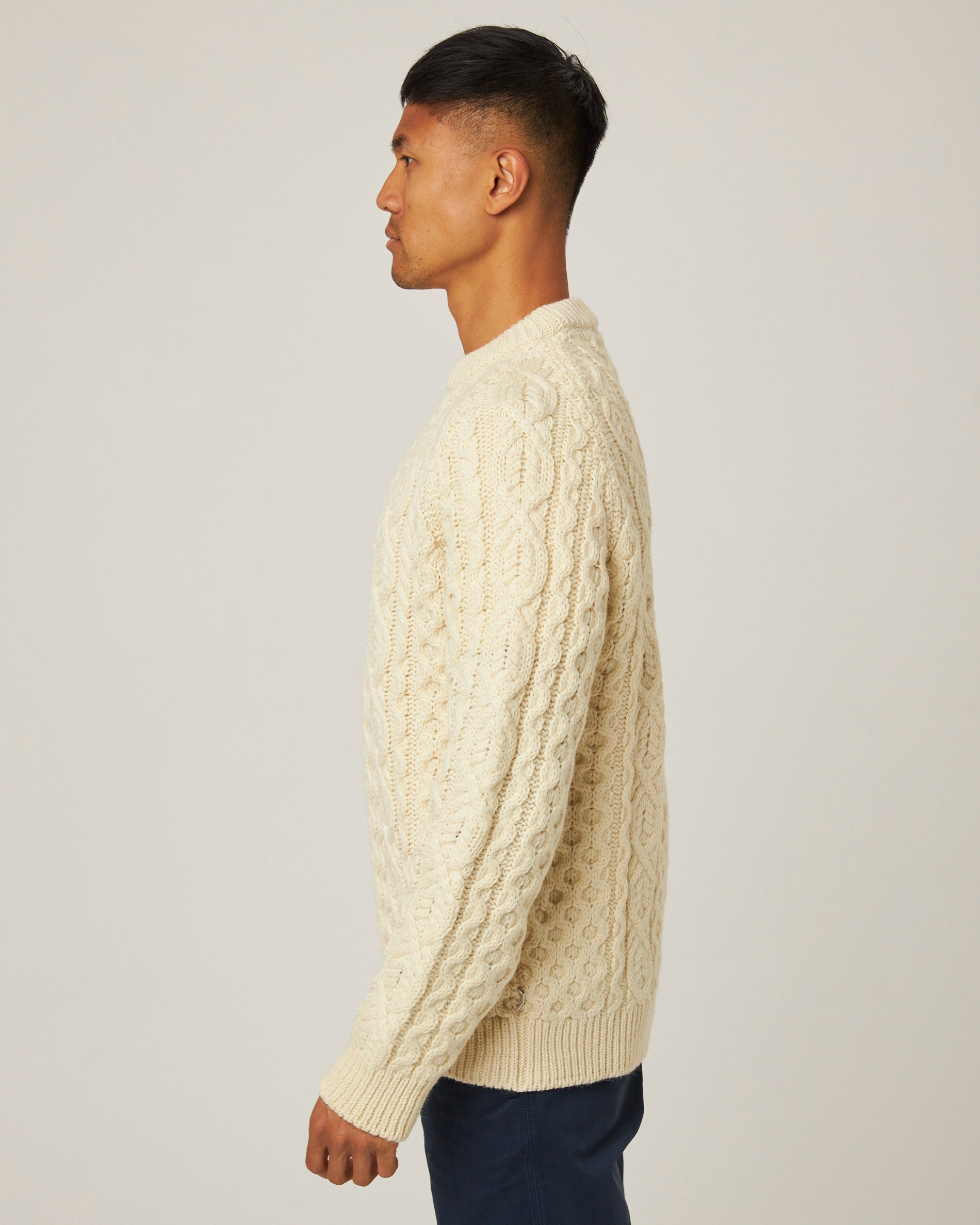 Image of model wearing Hudson Aran Jumper. Model is 6ft1in, chest size 38in and wearing size Large
