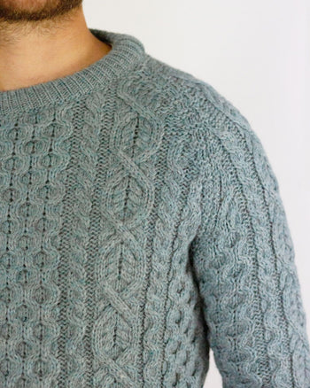 Image of model wearing Hudson Aran Jumper. Model is 6ft1in, chest size 40in and wearing size Large