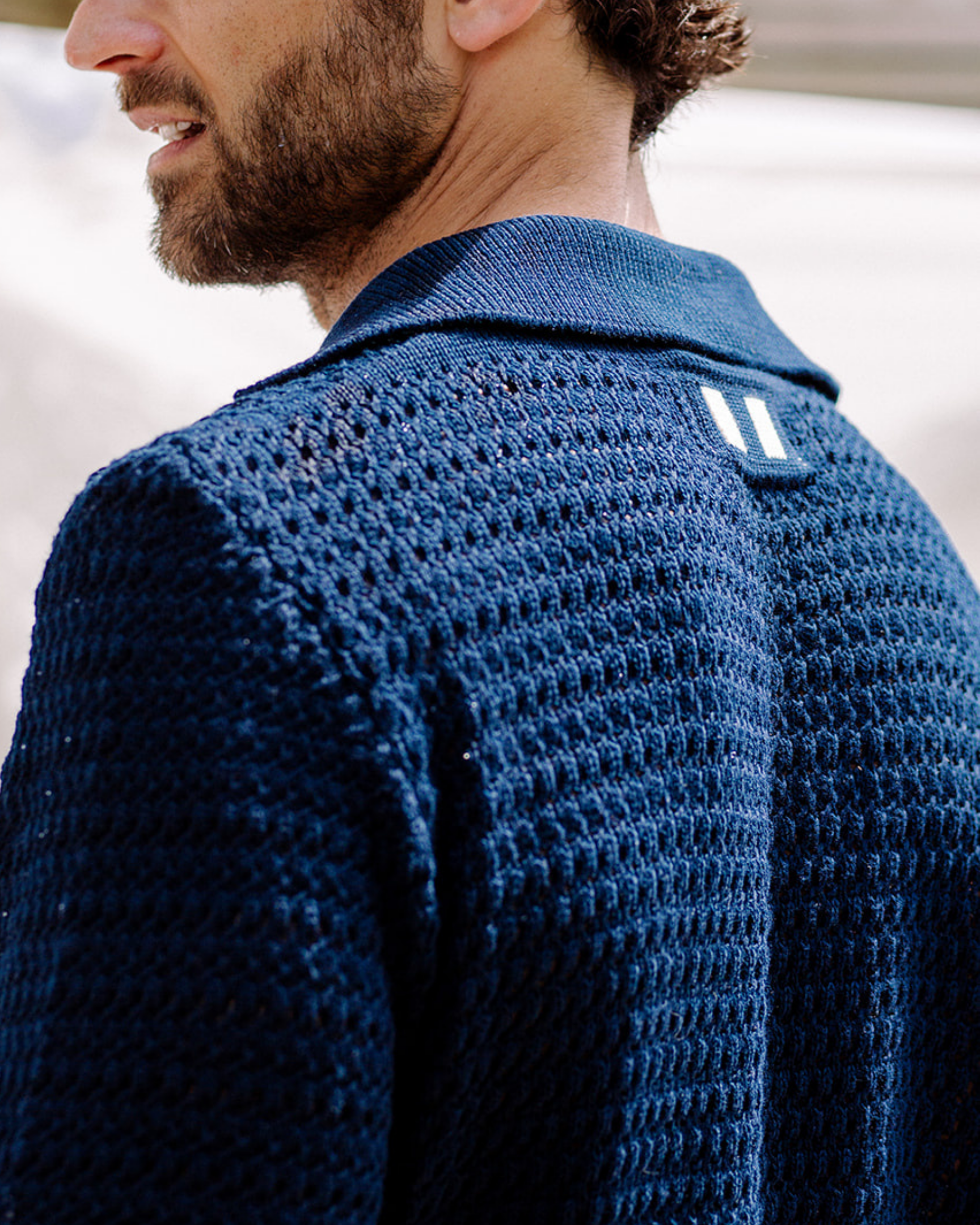 Image of model wearing Island Crochet Polo Shirt. 