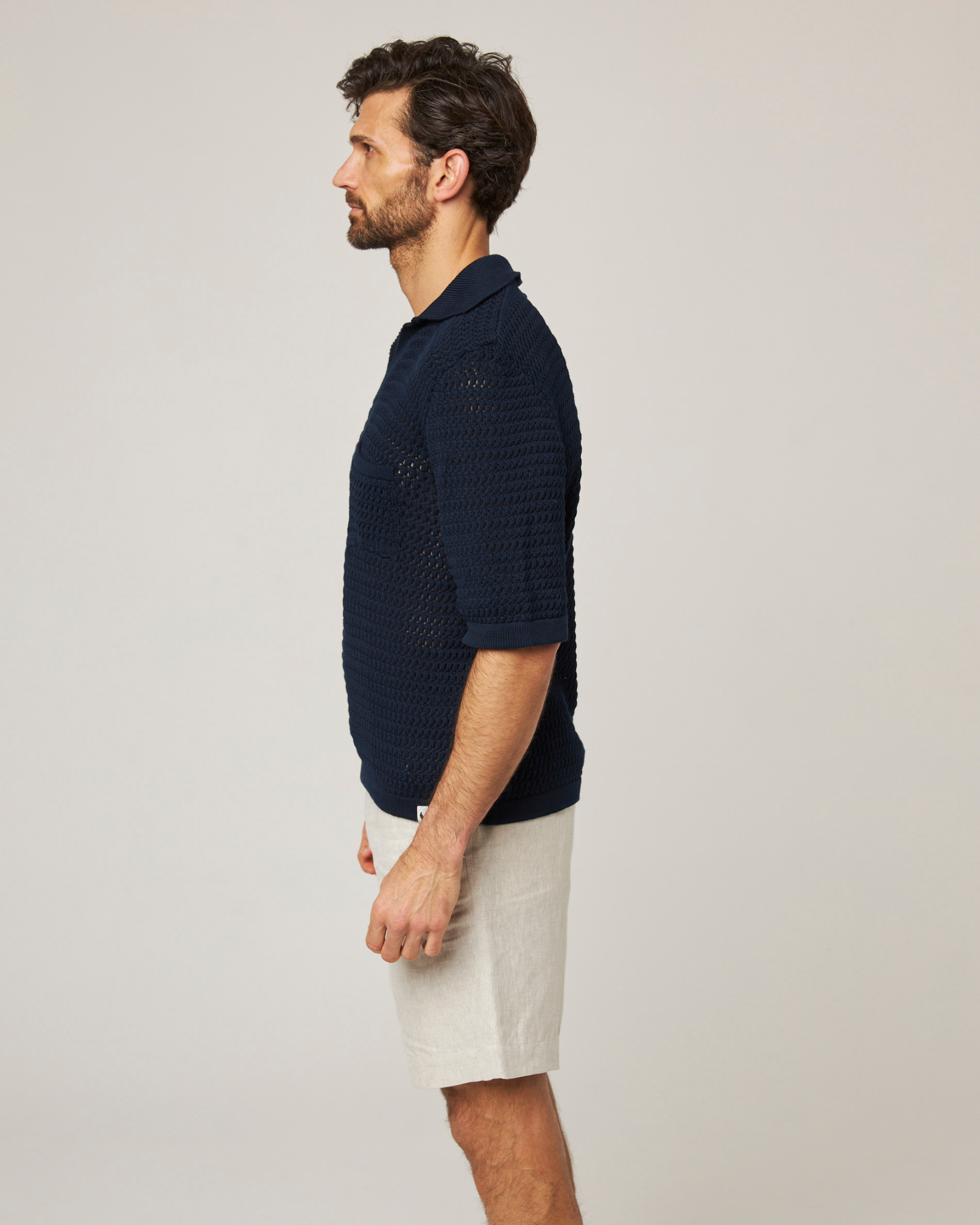 Image of model wearing Island Crochet Polo Shirt. 