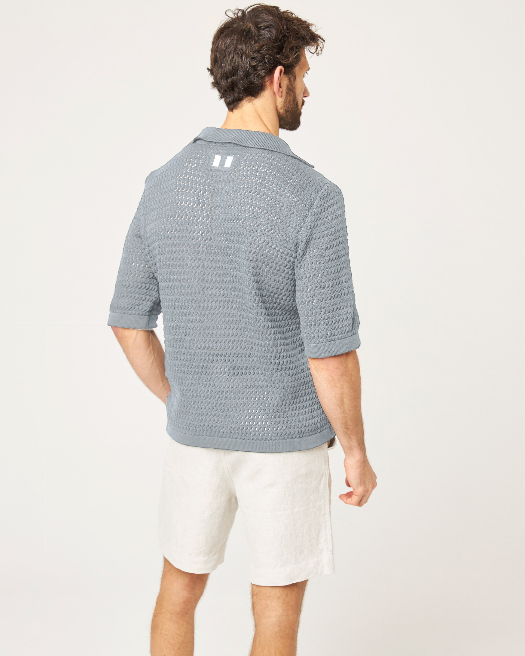 Image of model wearing Island Crochet Polo Shirt. 