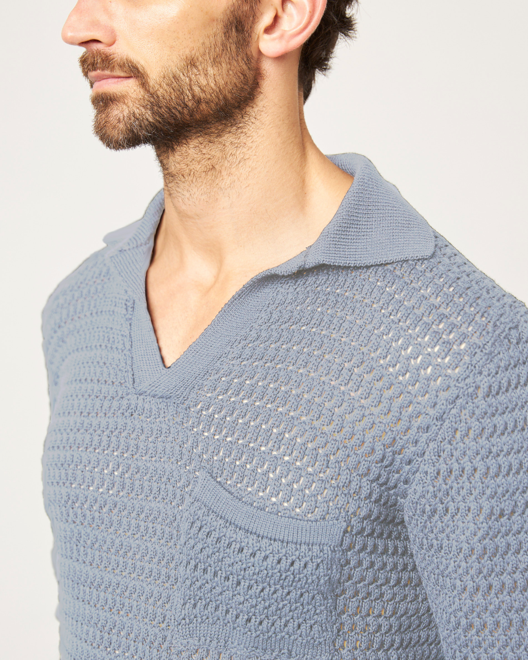 Image of model wearing Island Crochet Polo Shirt. 