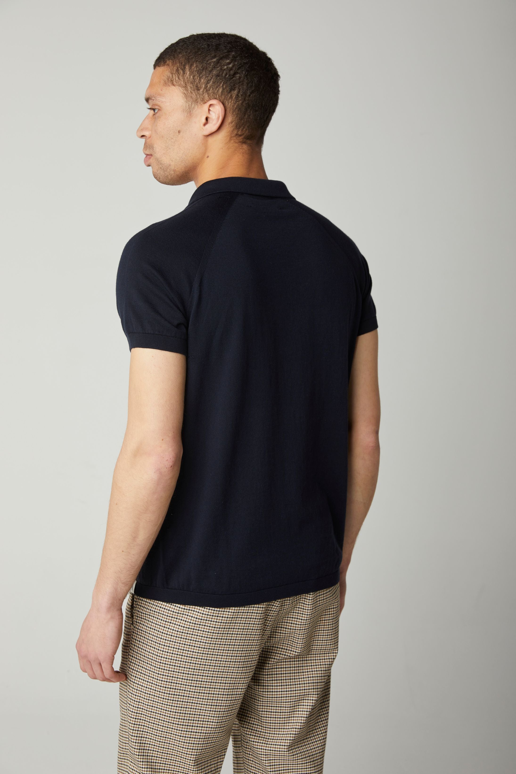 Image of model wearing Knitted Emery Polo Shirt. Model is 6ft, chest size 36in and wearing size Medium