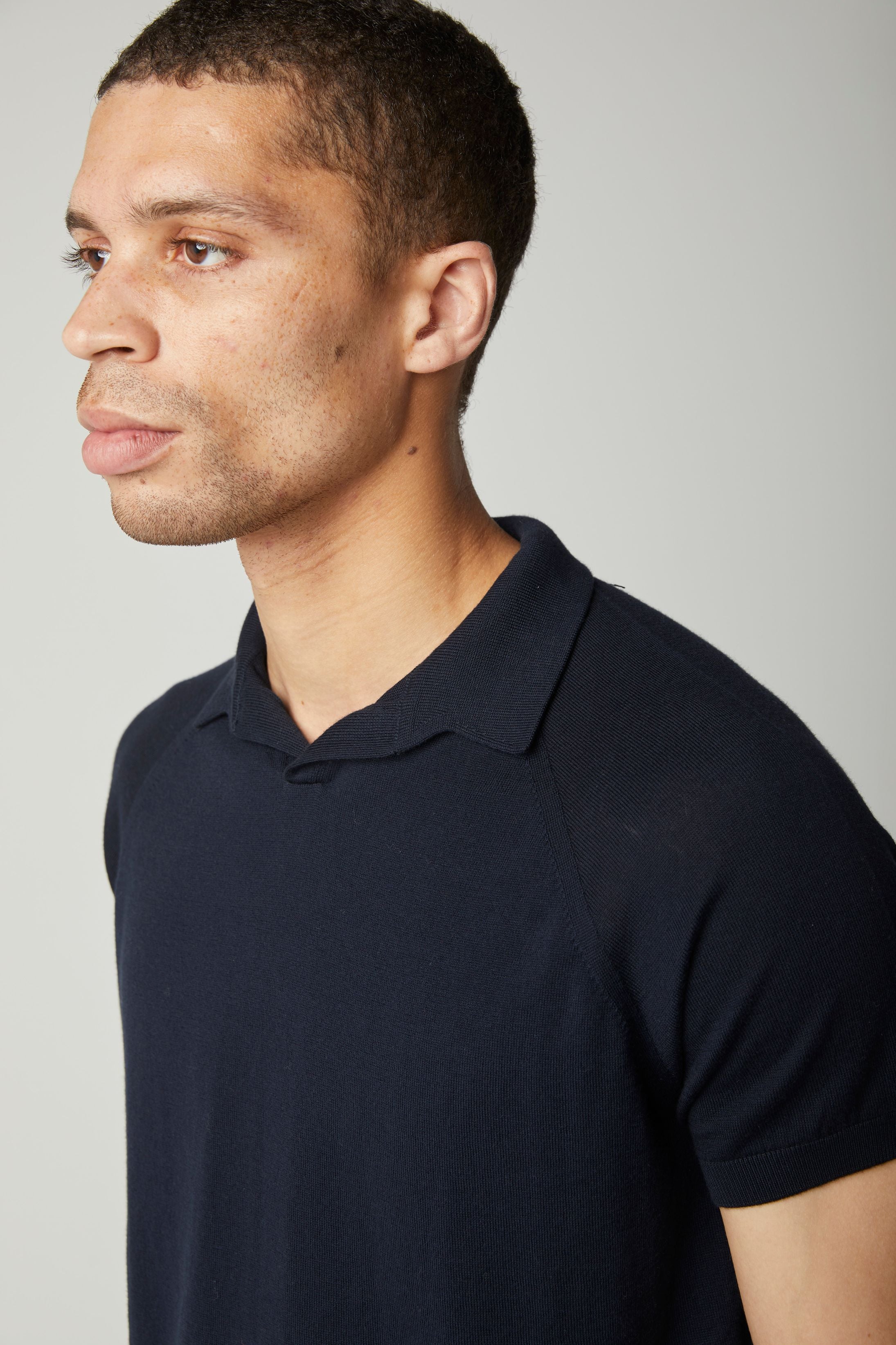 Image of model wearing Knitted Emery Polo Shirt. Model is 6ft, chest size 36in and wearing size Medium
