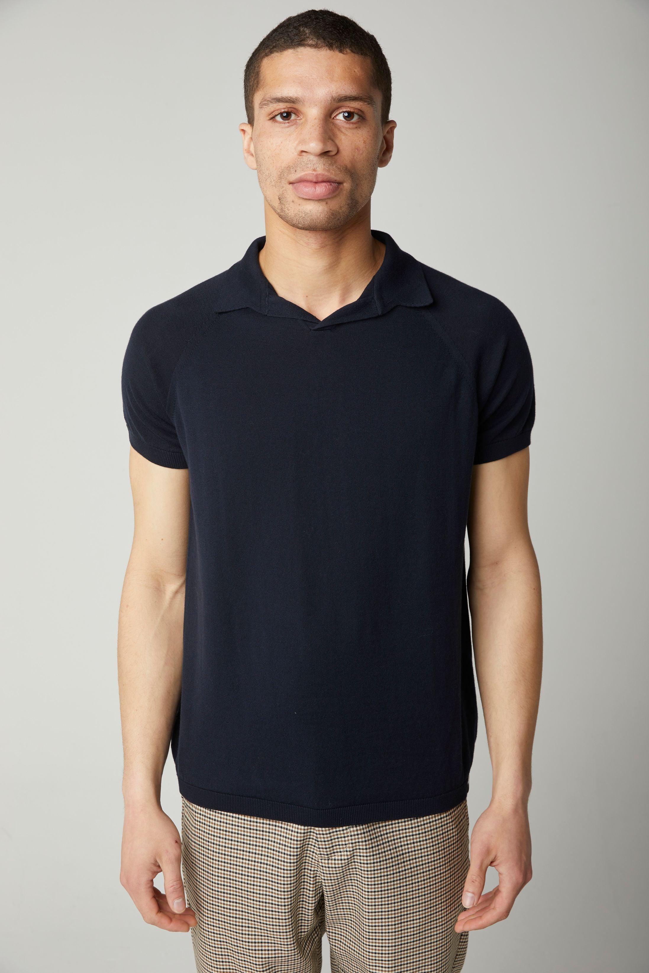 Image of model wearing Knitted Emery Polo Shirt. Model is 6ft, chest size 36in and wearing size Medium