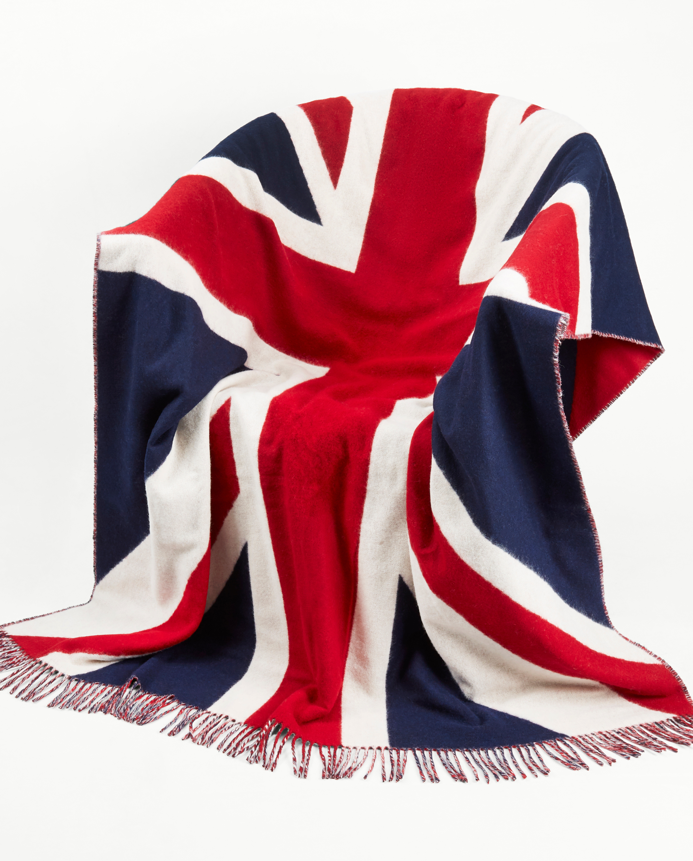Image of model wearing Union Jack Wool Blanket. Size: 200cm x 135cm (includes fringe)