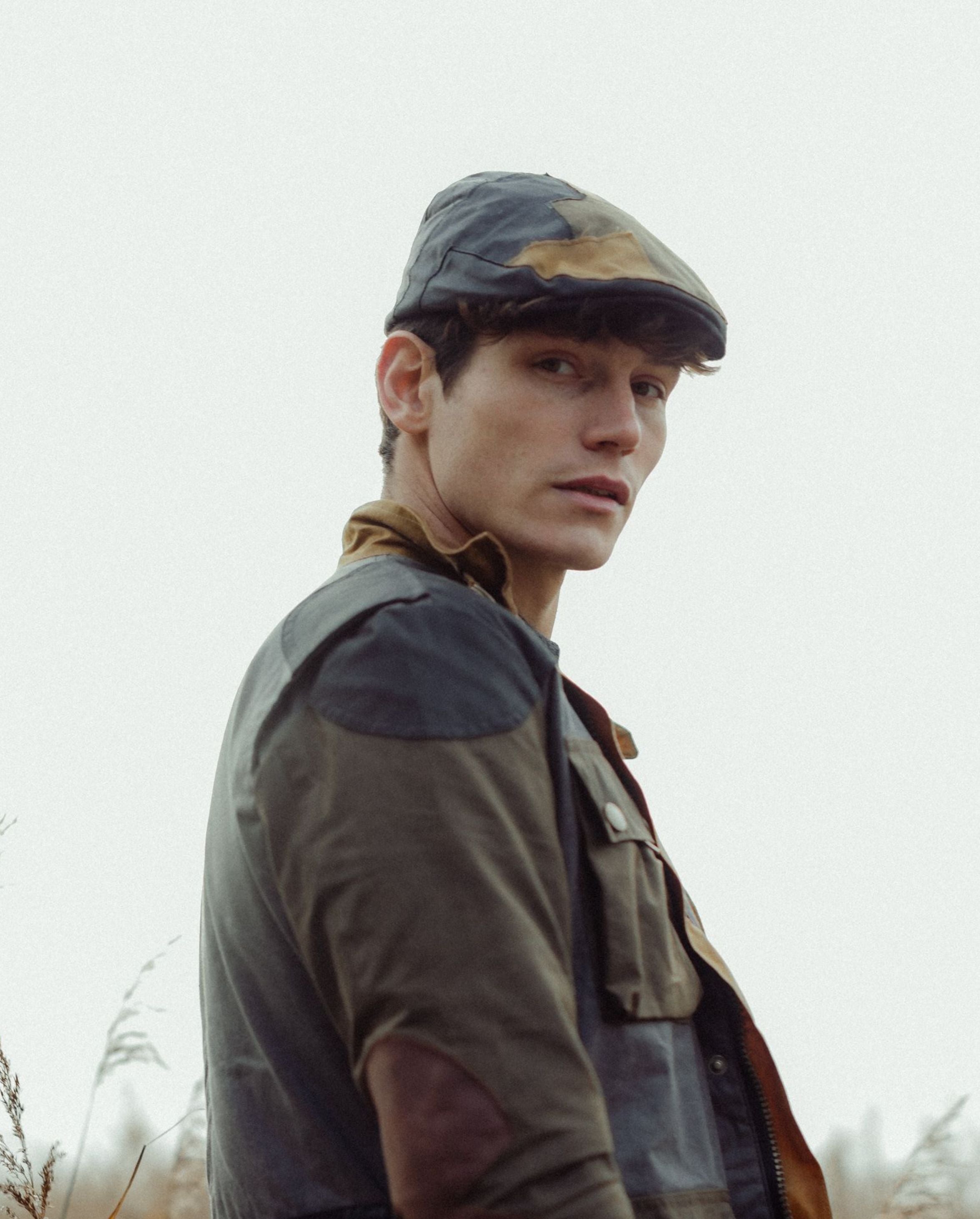 Image of model wearing Wax Flat Cap. 