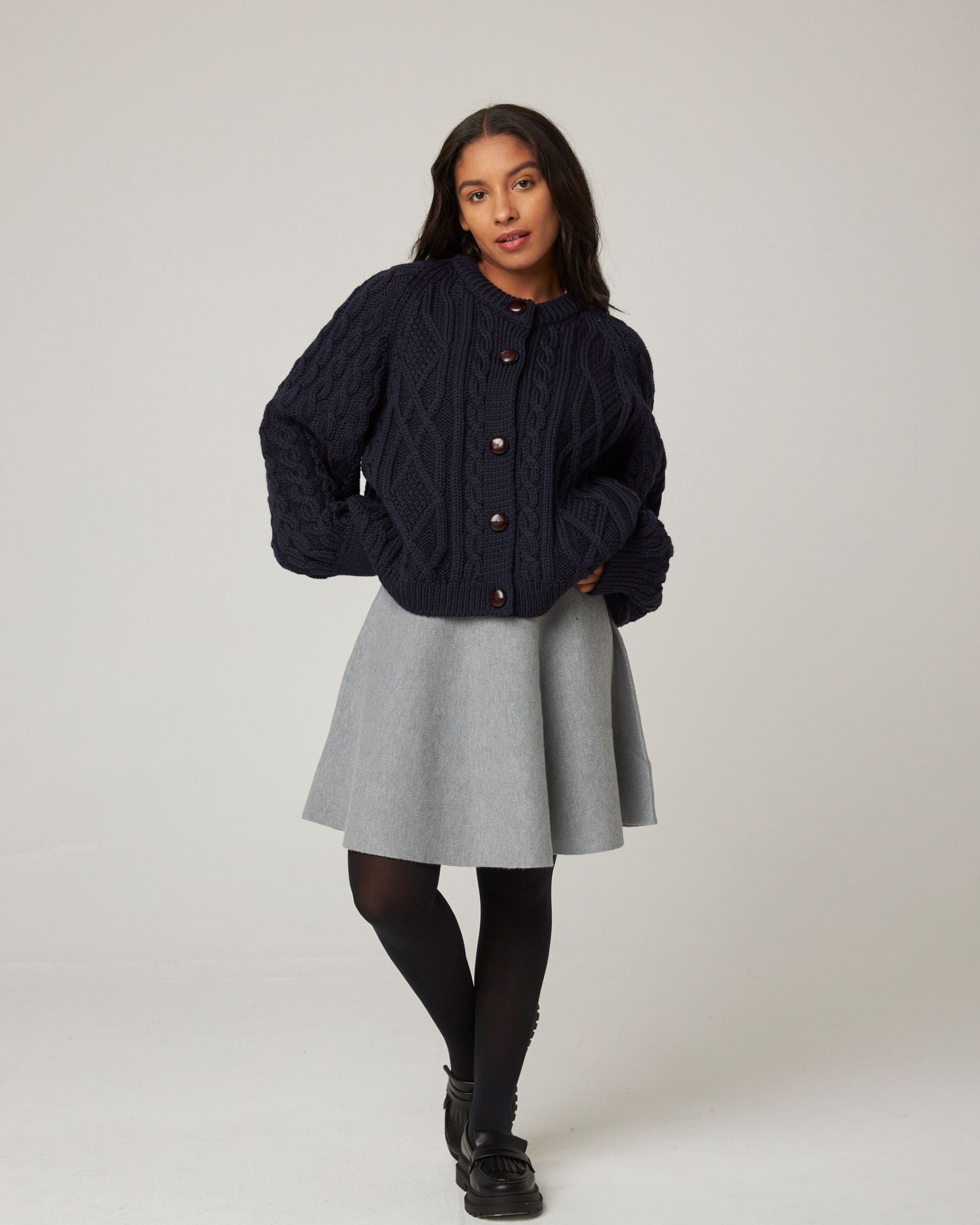 Image of model wearing Beckett Cable Knit Cardigan. 