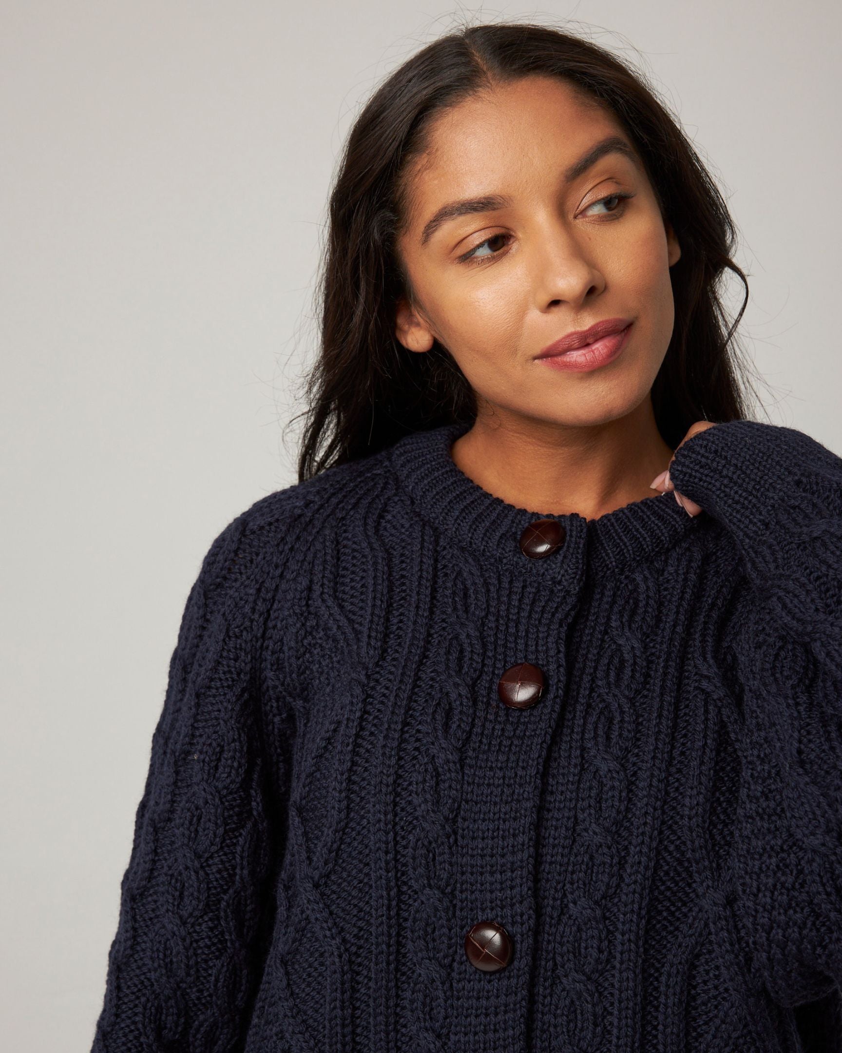 Image of model wearing Beckett Cable Knit Cardigan. 