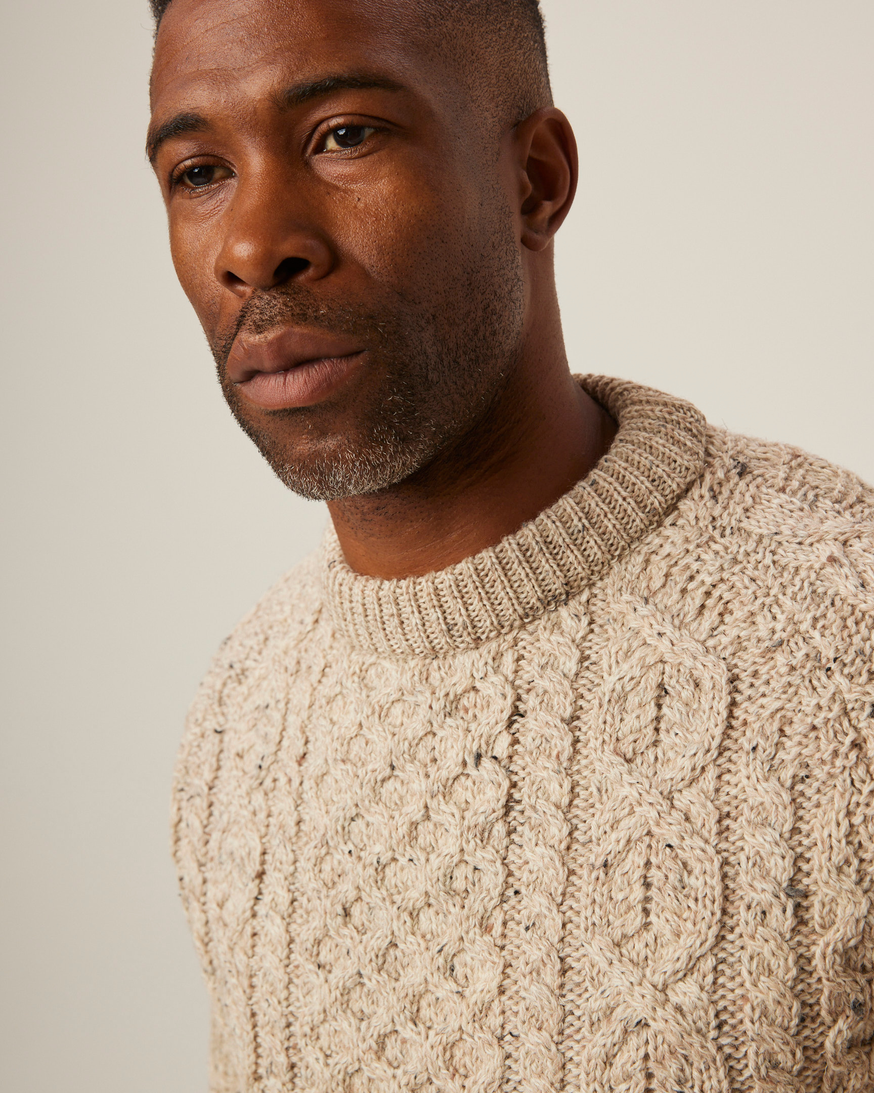 Image of model wearing Hudson Aran Jumper. Model is 6ft, chest size 36in and wearing size Large