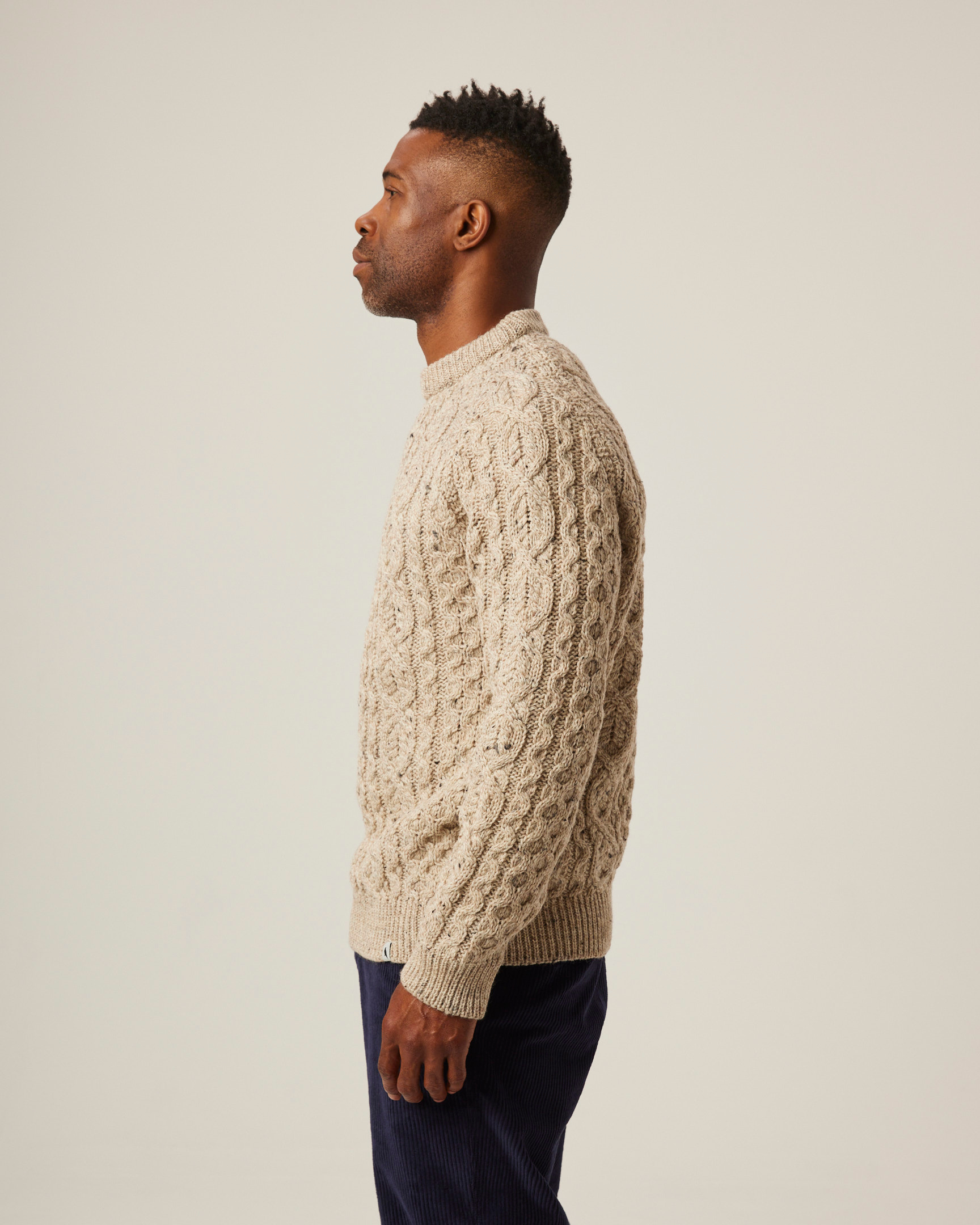 Image of model wearing Hudson Aran Jumper. Model is 6ft, chest size 36in and wearing size Large