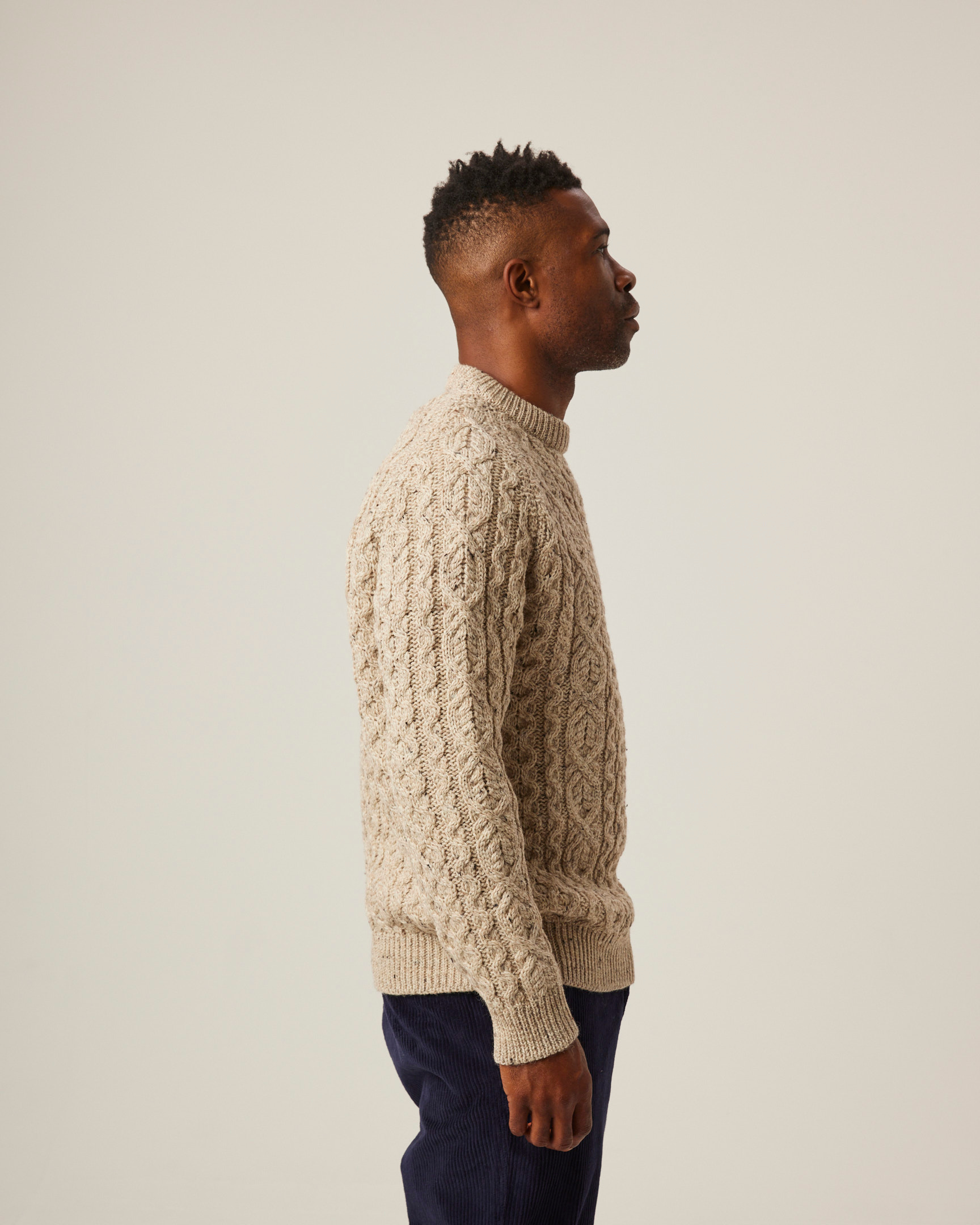 Image of model wearing Hudson Aran Jumper. Model is 6ft, chest size 36in and wearing size Large
